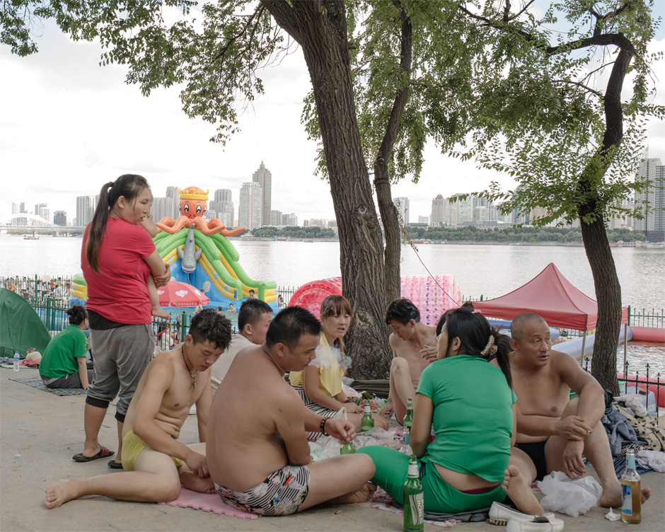 A group of Chinese people picnic on the bank of the Songhua River in Harbin. Formerly a small fishing village, the city expanded rapidly in the 19th century as Russian engineers constructed the eastern portion of the Trans-Siberian Railway.