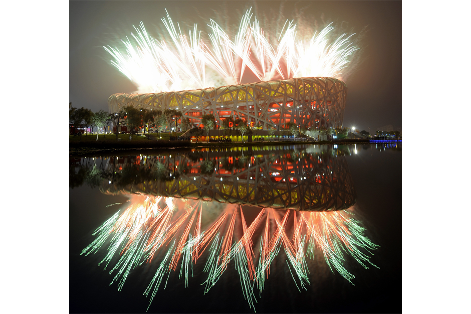 Fireworks explode next to the “Bird’s Nest” Stadium during the opening ceremony of the 2008 Beijing Olympic Games, August 8, 2008. (Photo by Franck Fife/AFP/Getty Images)