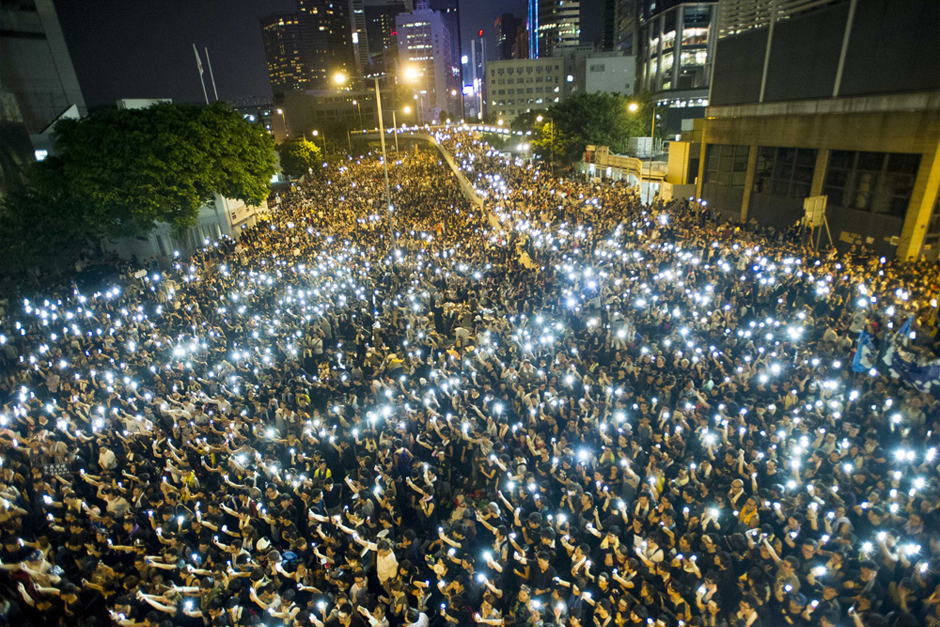 Protesters gather in the streets outside the Hong Kong government headquarters on September 30. Thousands of pro-democracy supporters have remained in the streets of Hong Kong for days of protests. (Photo by Xaume Olleros/AFP/Getty Images)