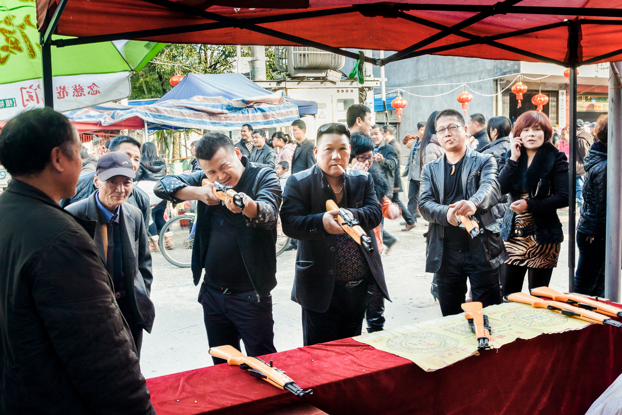 People play with air guns at a Lantern Festival celebration in Ancao village, February 6, 2012.