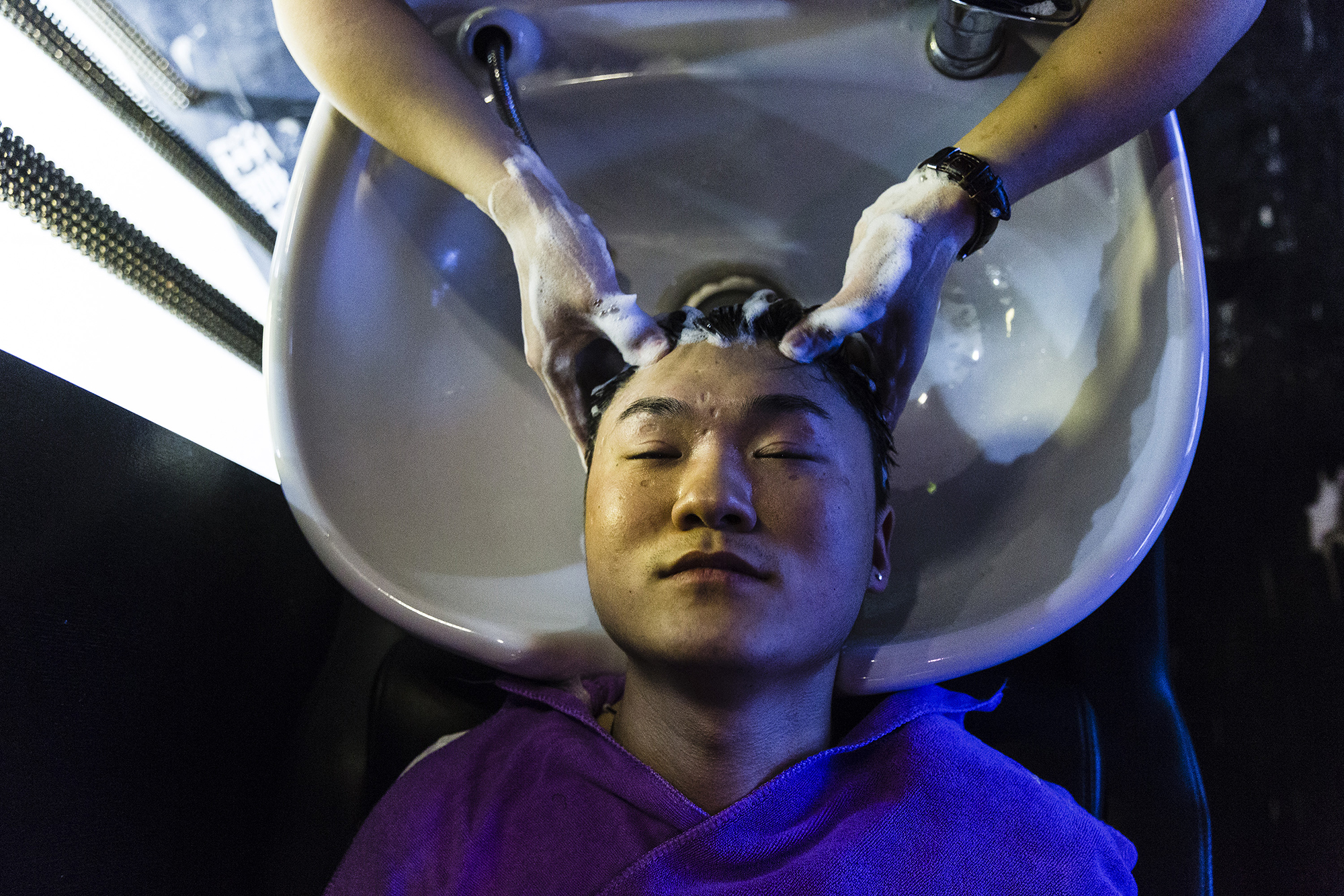 Software engineer and Puamap student Jiang Shuai gets his hair styled at a salon, May 15, 2015. 