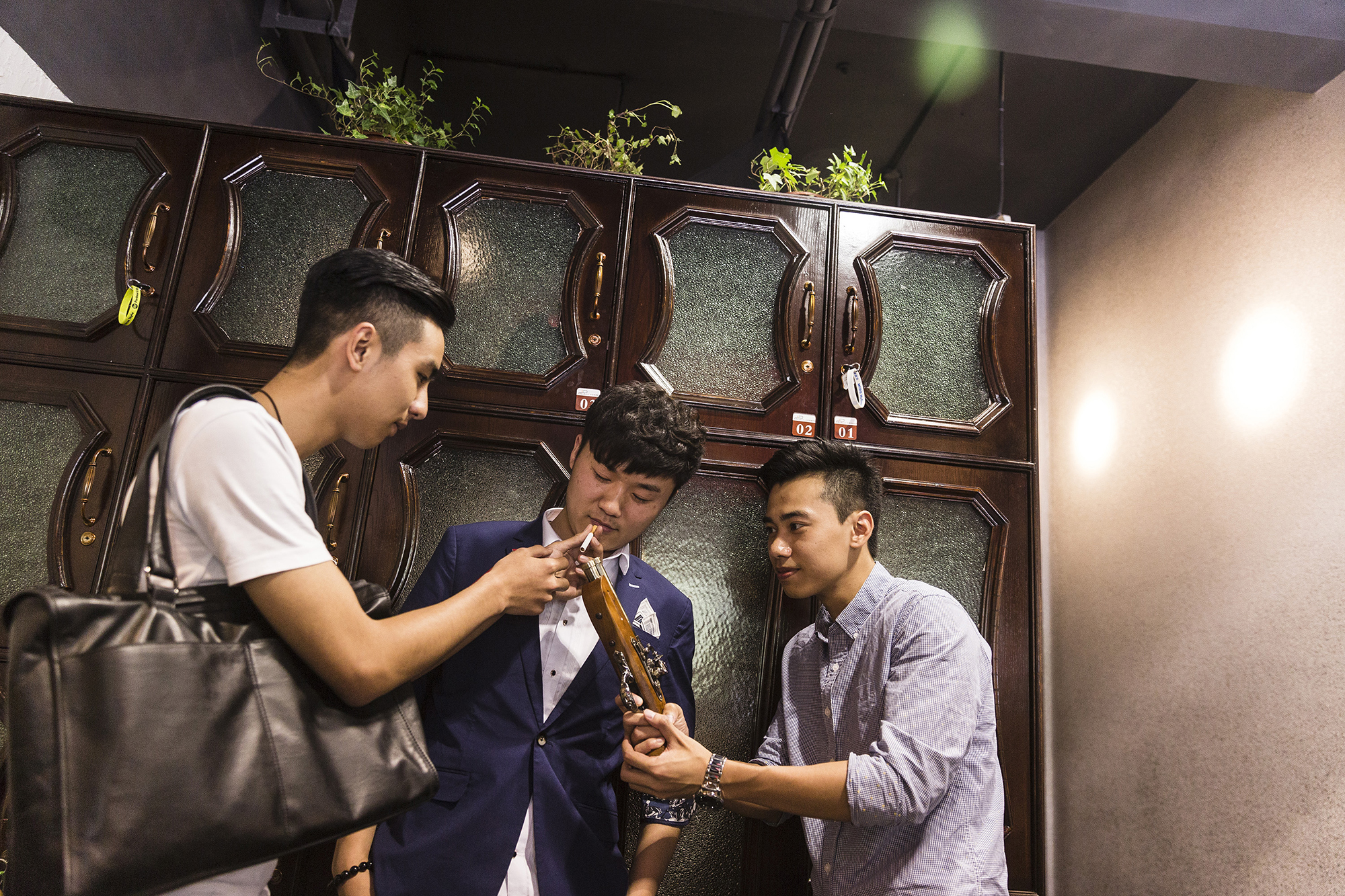 After updating his hairstyle, Jiang (center) poses for new profile photos for his social media accounts, May 15, 2015. Improving one’s online presence is an important part of Puamap’s course. 