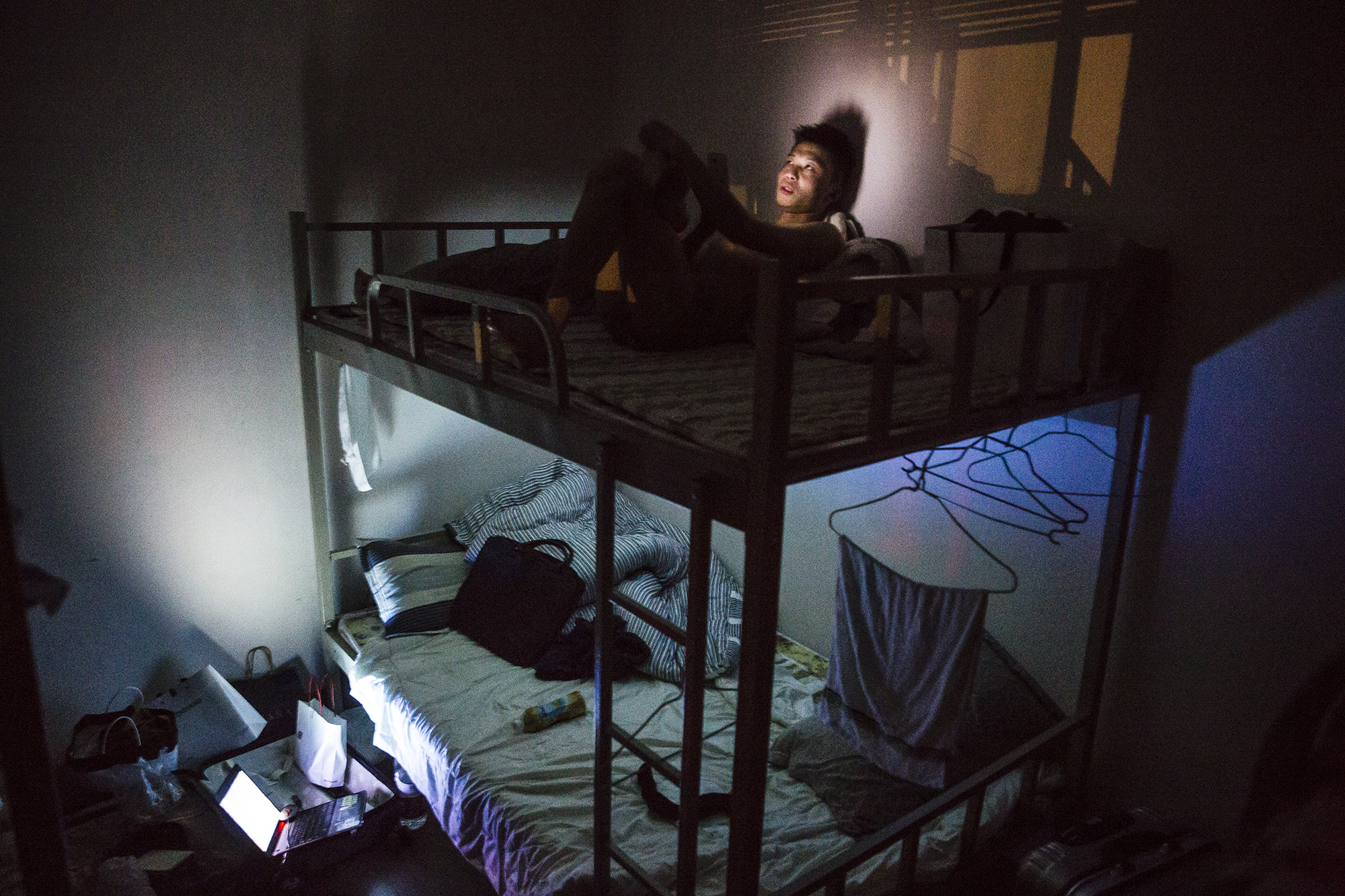 An employee at a technology company in Chongqing rests in the dormitory after the day’s courses, May 18, 2015. He said he couldn’t find a girlfriend because he was too shy towards women. He participated in Puamap because his family wanted him to get married.