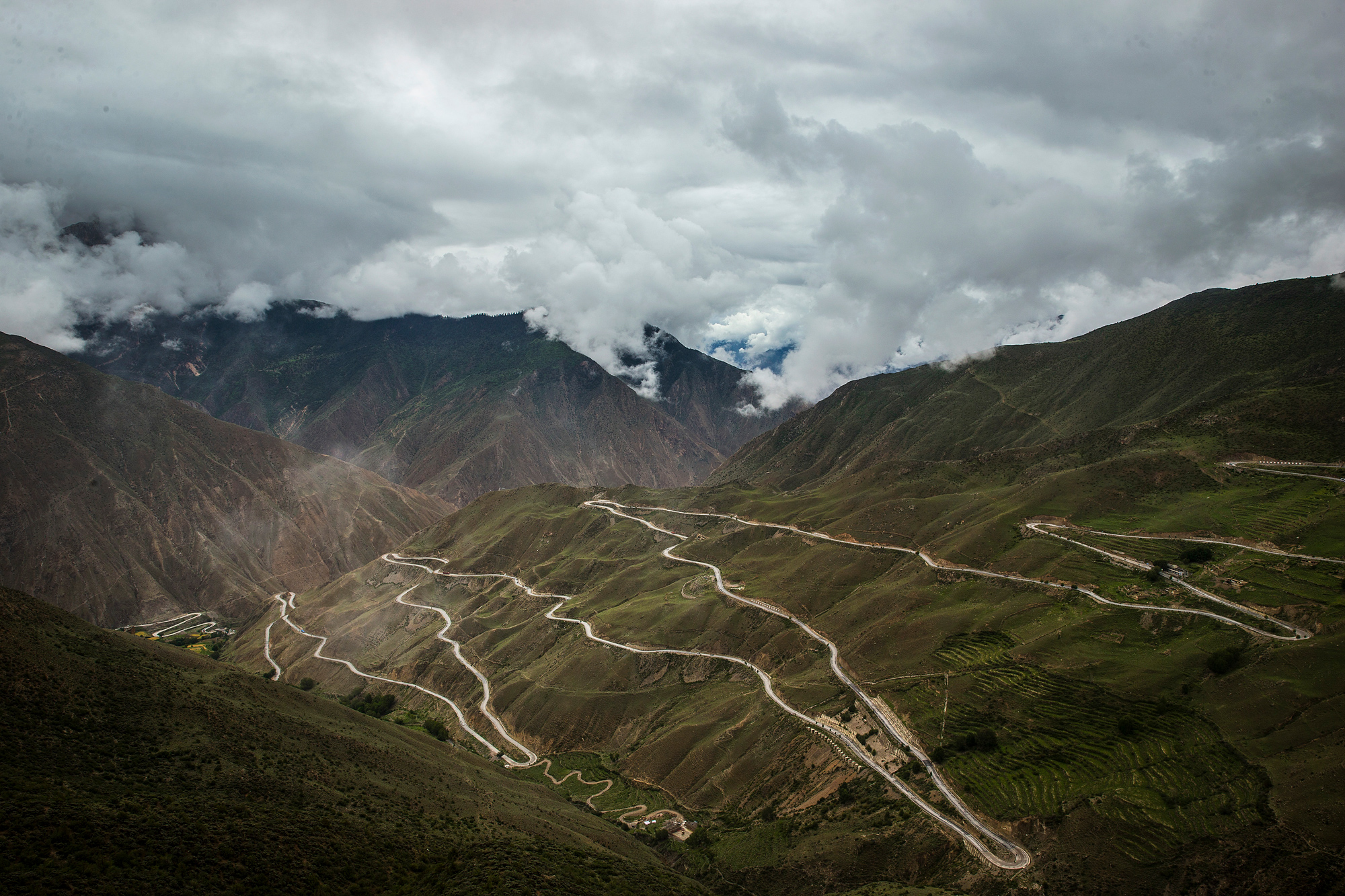 Another challenging location on the route is known as the Nu River 72 Turns, a series of treacherous switchbacks in Qamdo, where the road climbs from 13,451 feet above sea level to a high point of 15,259 feet, before dropping back down to 10,170 feet, July 29.