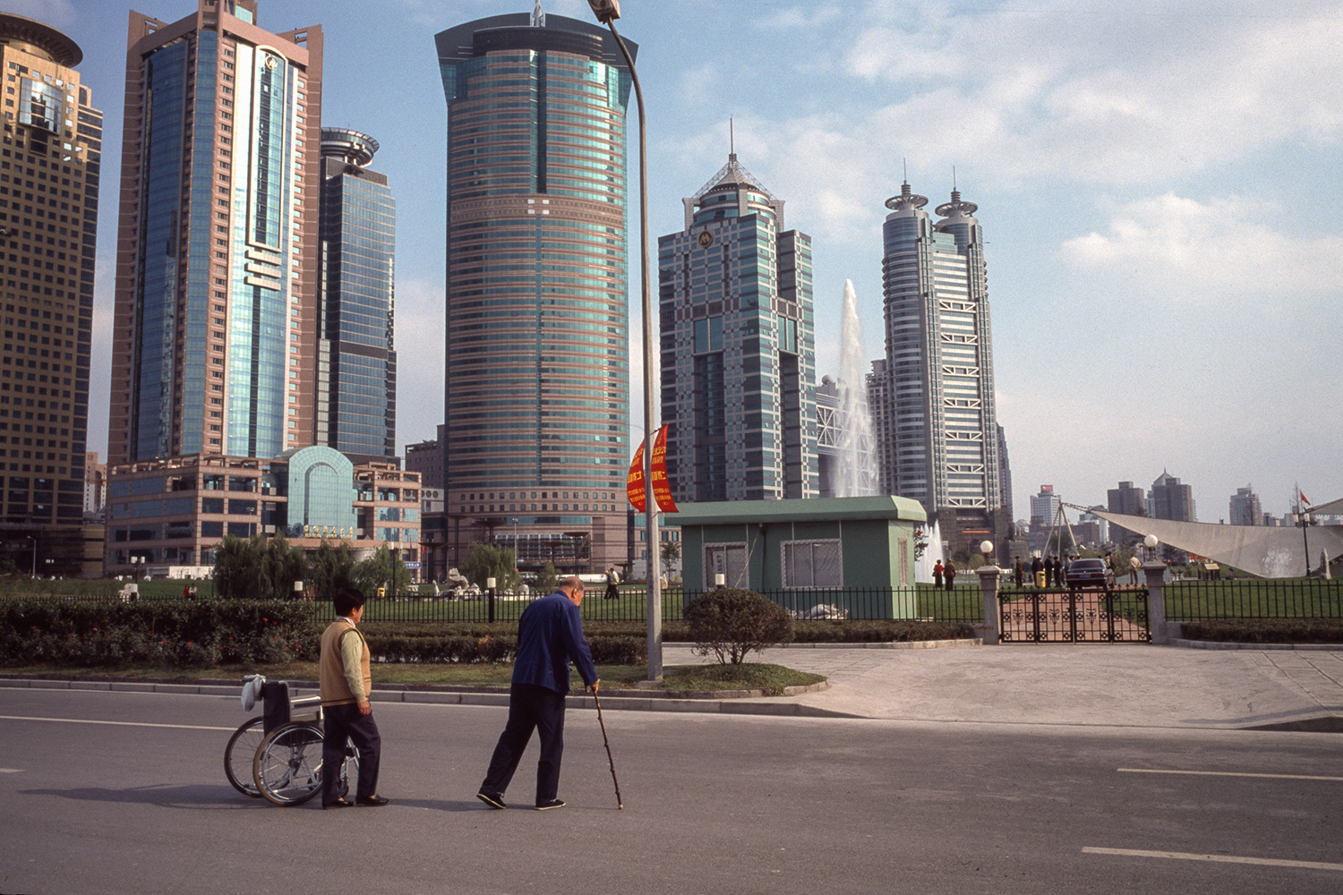 Two elderly people cross Yincheng Road to the Central Green, 2003.