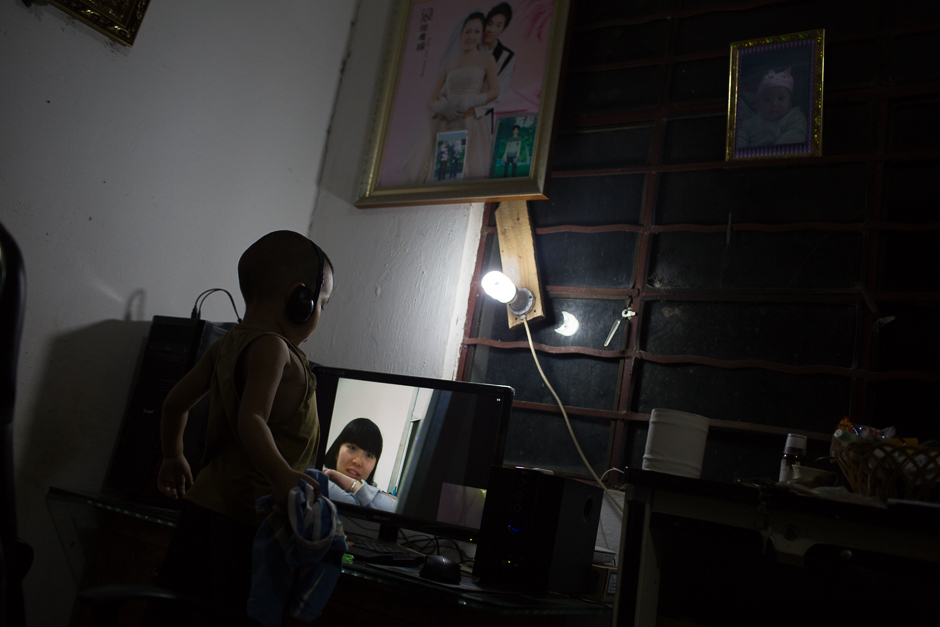 Four-year-old Le video chats from his home in Yunnan province with his mother, a migrant worker living in Zhejiang province. Le lived with his uncle and aunt in Xiaxinzhai village, Zhemi county. For most of his life, Le has lived apart from his 20-year-old parents, since they left to find work in 2012.