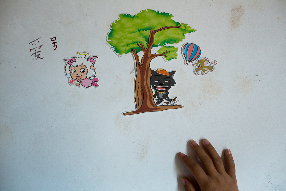 Jie’s room still has cartoon characters on the wall and the Chinese character for “hobby,” although the character is incorrectly written.