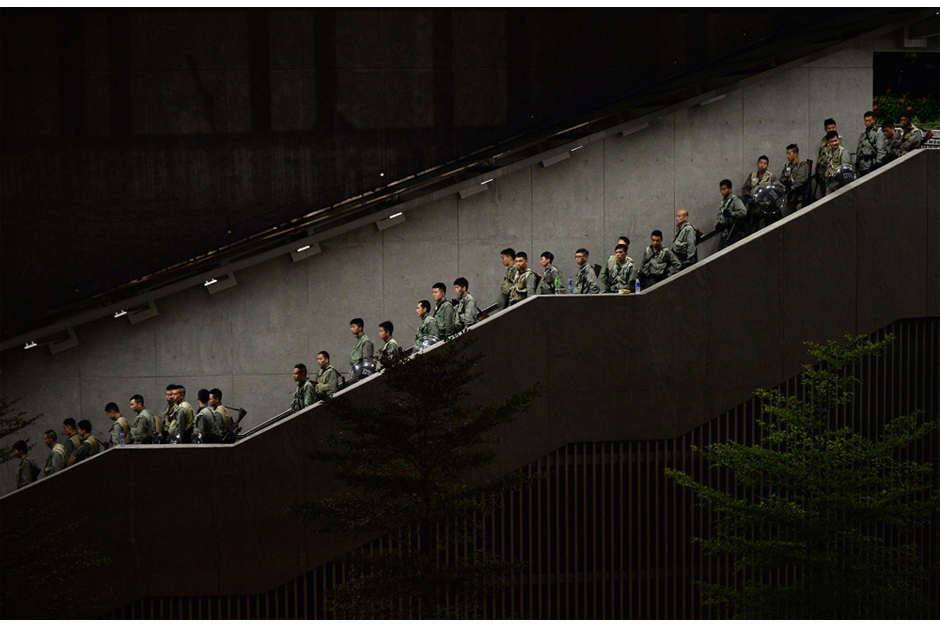 Police walk down a stairwell. (Photo by Dale de la Rey/AFP/Getty Images)