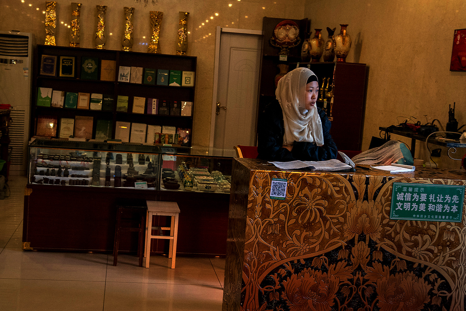 A receptionist inside the Aisha Palace waits to greet visitors. The palace serves as a temporary museum until construction of the main museum is complete.
