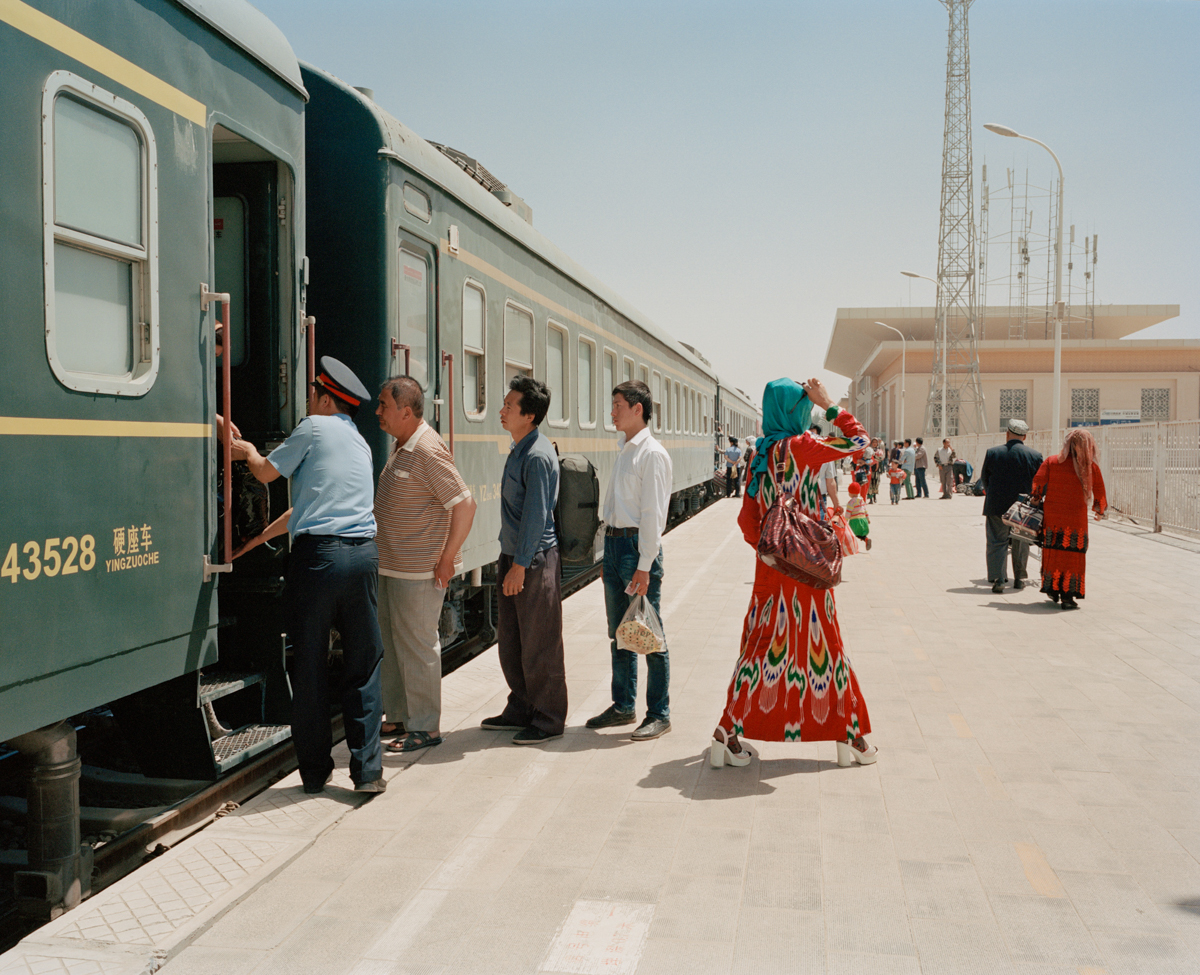 Travelers board and exit the train to Hotan at the Kashgar railway station, May 2016. One railway links the cities and towns south of the Taklamakan desert, where most of the Uyghur community in Xinjiang lives.