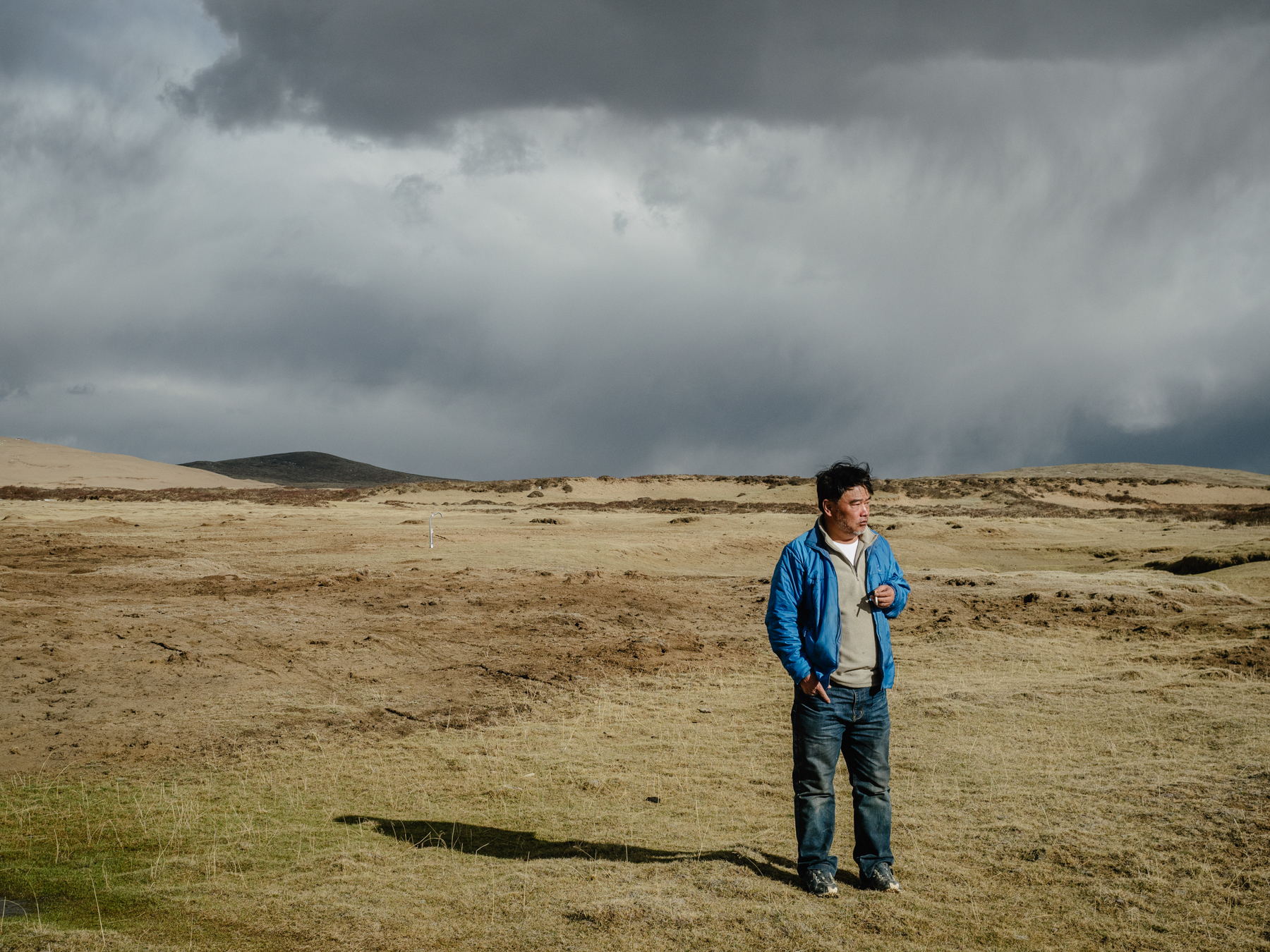 Geologist and environmentalist Yang Yong takes a cigarette break after a long drive. He says, “I’m not doing this for money or fame, I just want to know more. We know so little, and we are now at the point where everyone is concerned about this region and its relationship to climate change. The main discussion is regarding how we can protect, develop, and use it. It’s a massive area, and I can hardly explore every corner of the plateau. And time is running out [for me].”