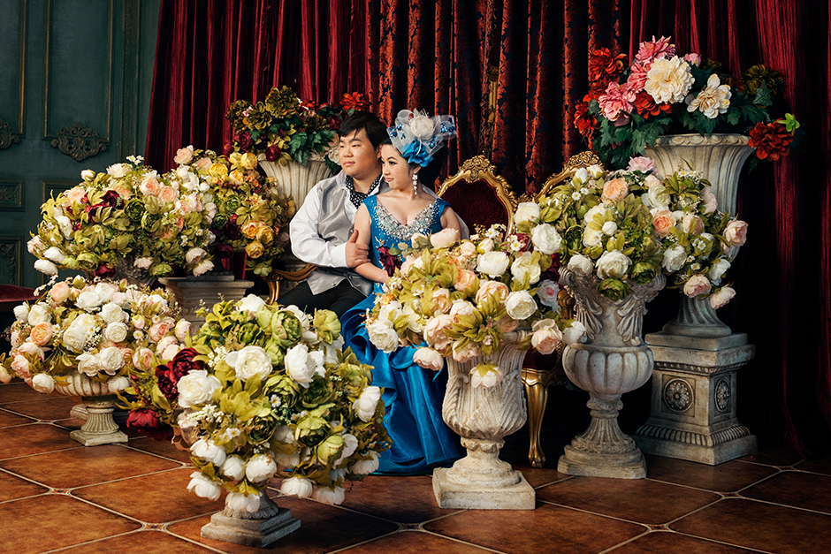 An engaged couple sits on-set at the Dream Castle studio.