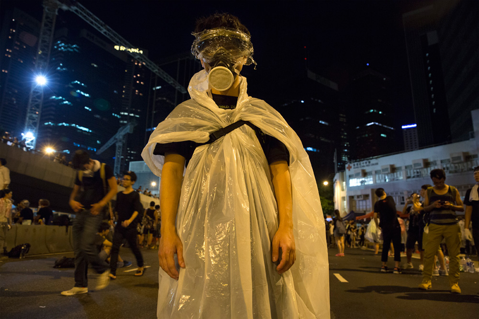 A pro-democracy protestor stands before a photographer in Hong Kong as thousands of others remain on the streets of the city after a weekend of protests. (Photo by Paula Bronstein/Getty Images)