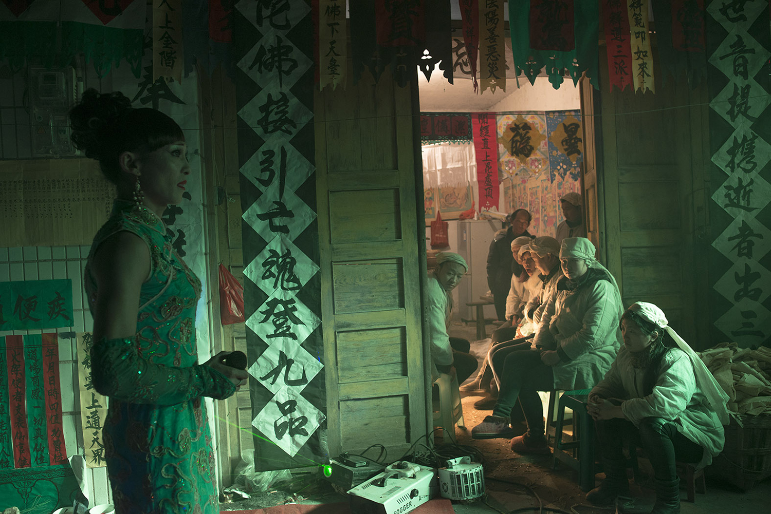 Family members of the departed watch Liangzi singing a song, December 23, 2014.
