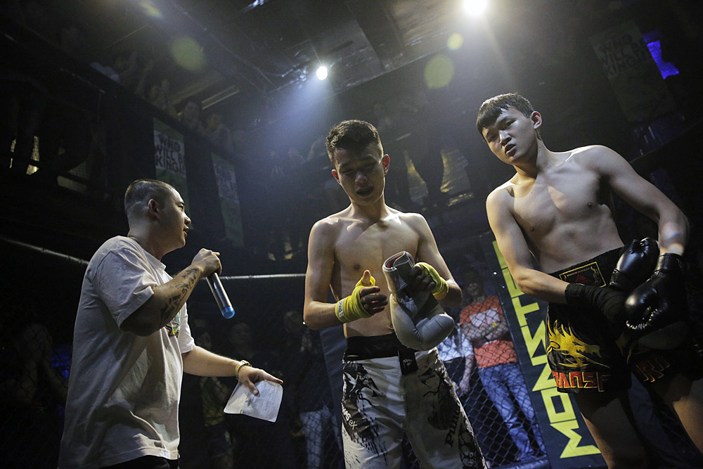 Xia (right), after winning the fight against Bo (center).