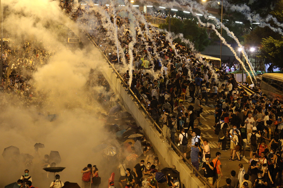 Police fire tear gas on pro-democracy demonstrators near the Hong Kong government headquarters. Parts of central Hong Kong came to a standstill September 28 in a dramatic escalation of protests that have gripped the semi-autonomous Chinese city for days. (Photo by Aaron Tam/AFP/Getty Images)