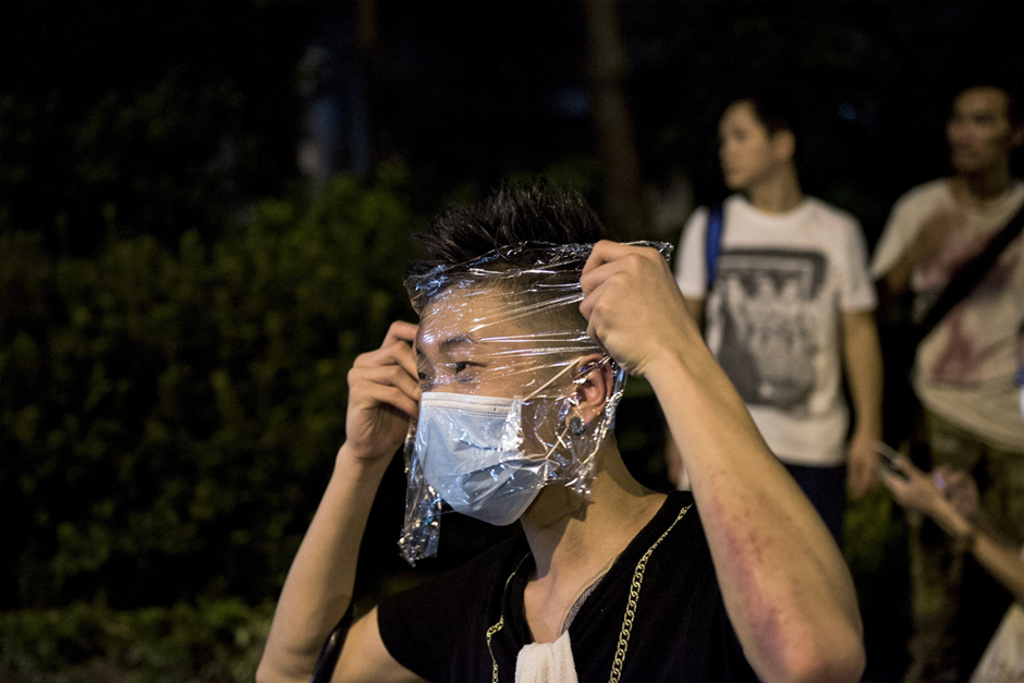 A pro-democracy protester wraps his face with plastic to protect himself against tear gas. (Photo by Alex Ogle/AFP/Getty Images)