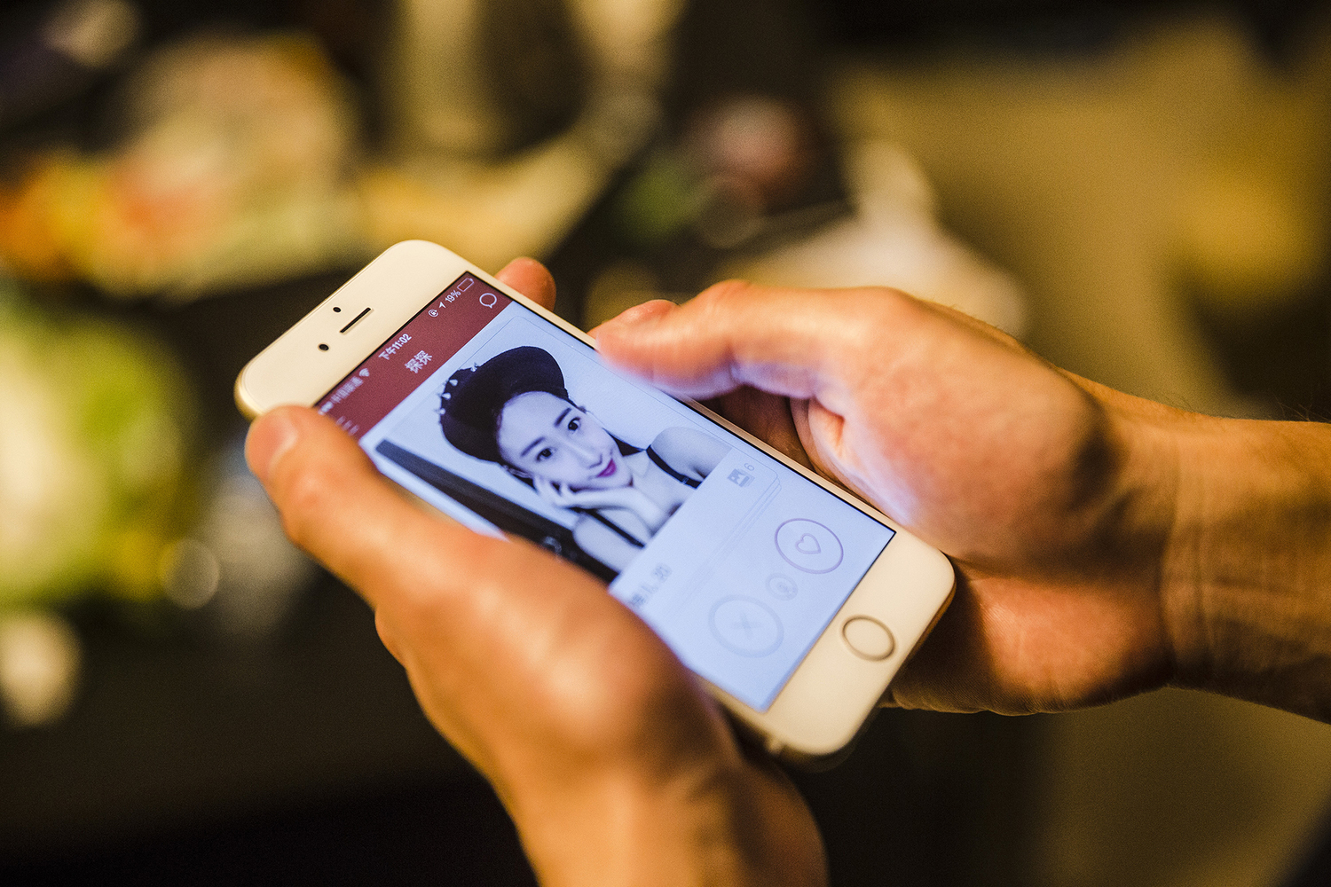 Students check a woman’s profile on the popular dating app Tantan, May 15, 2015. 