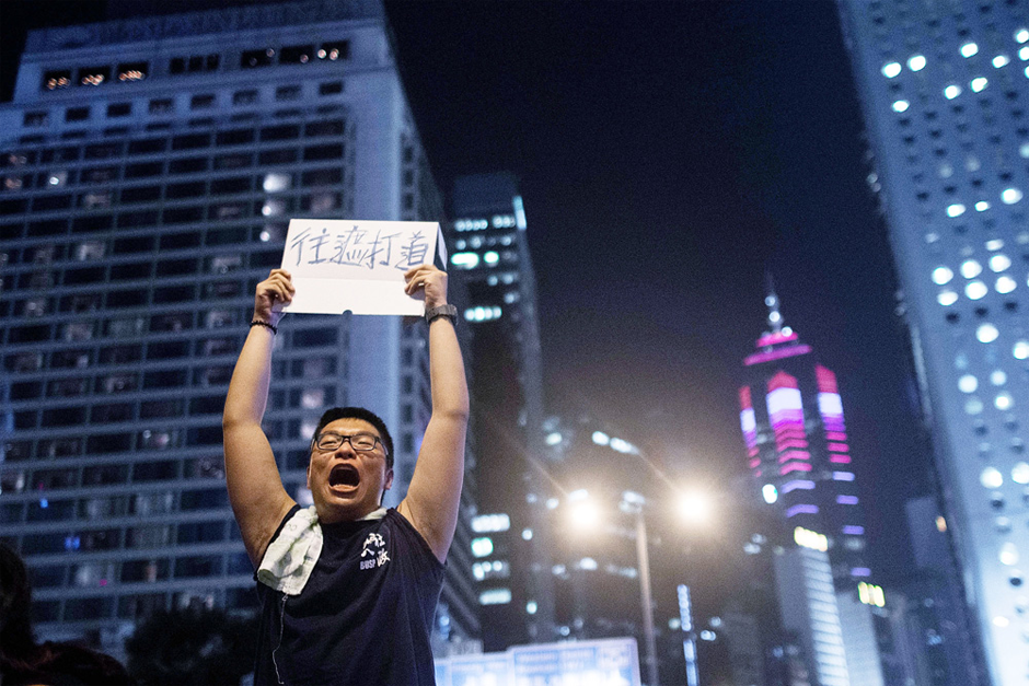 A protester instructs people to move to Chater Road in the Central District. (Photo by Anthony Kwan/Getty Images)