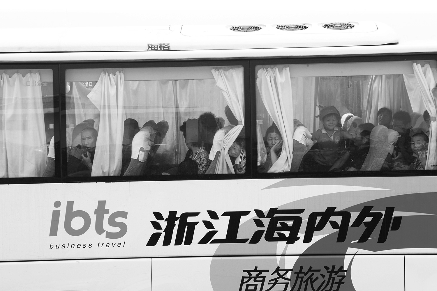 Some of the farmers board a bus to leave their homes and the village of Jinhe.