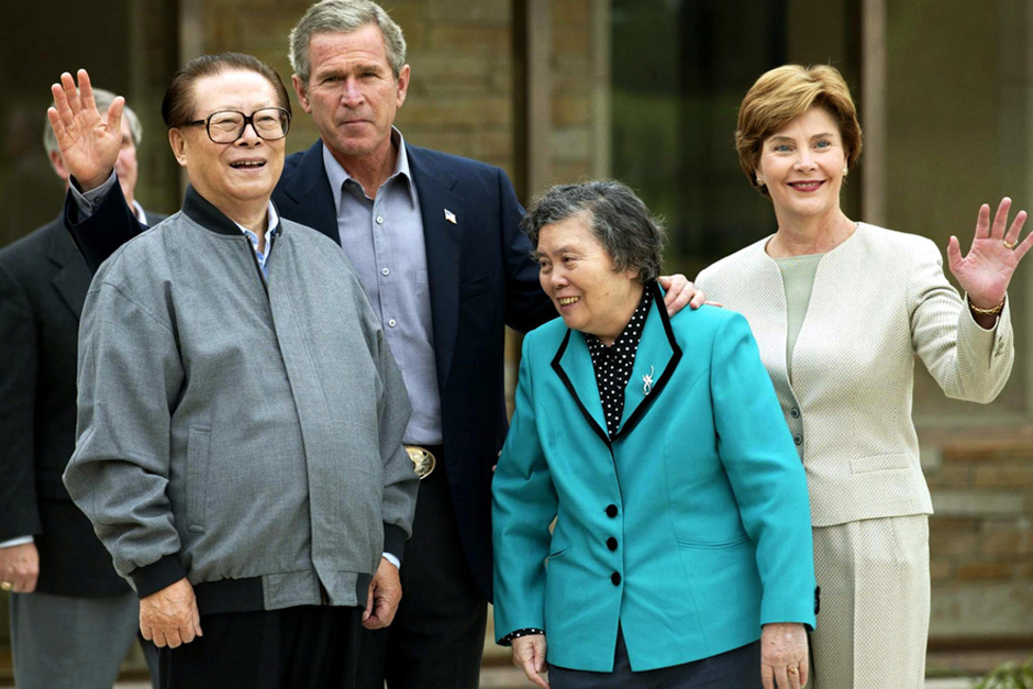 China’s President Jiang Zemin and his wife, Wang Yeping, join U.S. President George W. Bush and First Lady Laura Bush in addressing the media at Bush’s Prairie Chapel Ranch October 25, 2002 in Crawford, Texas. Jiang toured the Bush family ranch by truck and dined on Texas barbecue. (Photo by Stephen Jaffe/AFP/Getty Images)