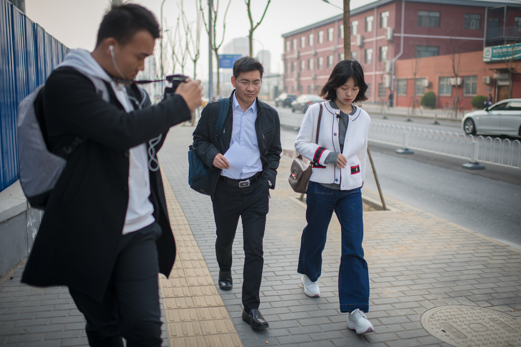 Zhou and her lawyer, Wang Fei, discuss the lawsuits, October 22. One person with knowledge of the alleged assault who now resides abroad refused to be listed as a witness. She said, “I don’t want to stir up all that stuff that happened back in China.”